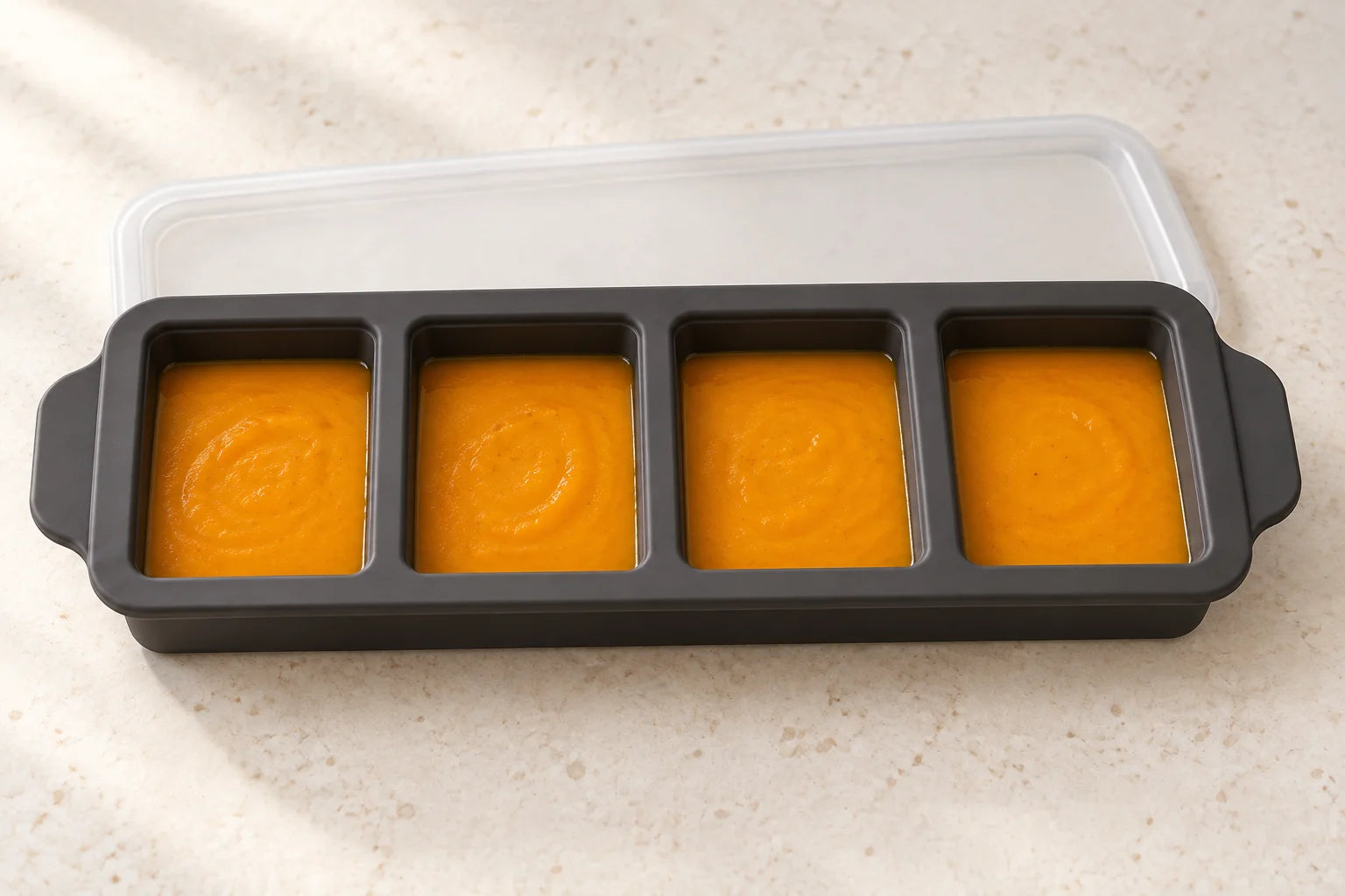 Butternut squash soup portioned in a Ink tray with 4 compartments