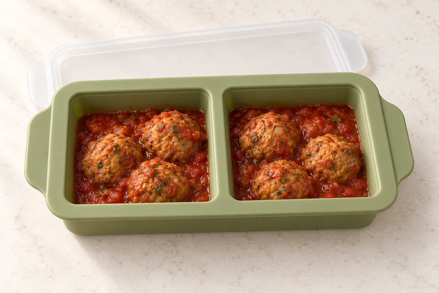 Turkey meatballs in tomato sauce portioned in a Olive tray with 2 compartments