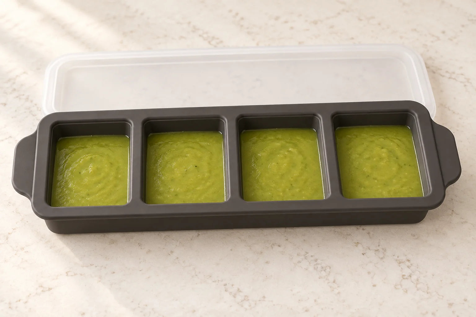 Pea & mint soup portioned in a Ink tray with 4 compartments